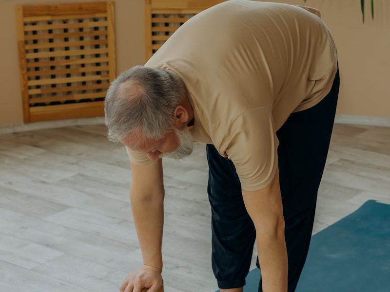 Detailed shot of a wooden yoga block and a mat.