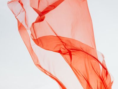 Soft silk fabric flowing in a breeze near window.